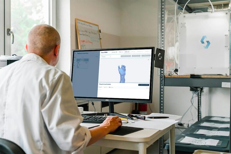 man in white dress shirt sitting in front of computer